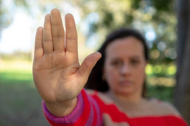istock Unrecognizable woman with raised hand. Concept of stop 1444962144