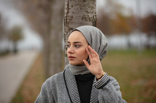 Portrait of beautiful hijab woman.
A girl in a beautiful dress and in public park.