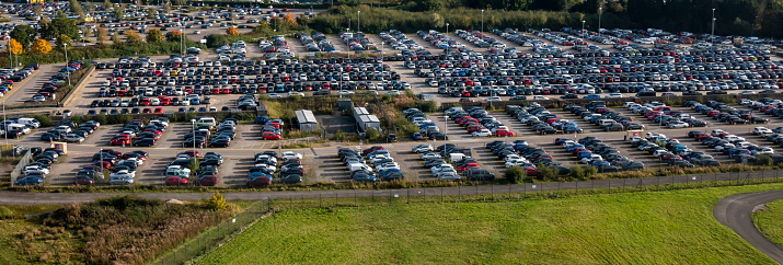 aerial panorama of busy airport parking facility on a sunny day