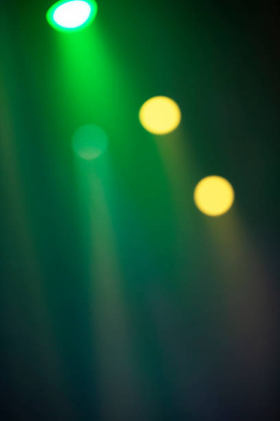 istock Green stage light from spotlights on a dark background. 1444963302