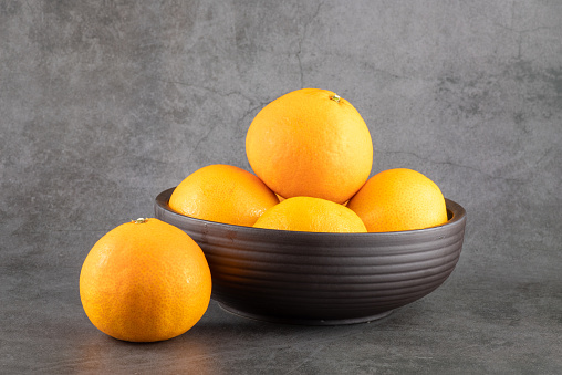 Tasty sweet orange fruit in bowl isolated
