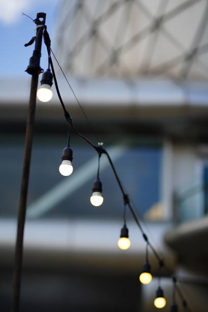 istock Row of illuminated light bulb hanging. 1444965197