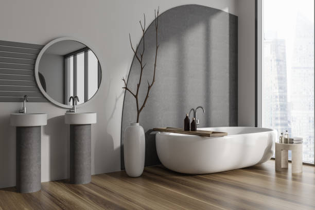 istock Stylish bathroom interior with double sink and tub near window. Copy space 1444966332