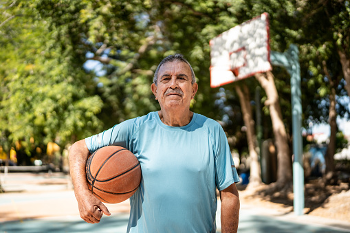 Portrait of senior man at the basketball court