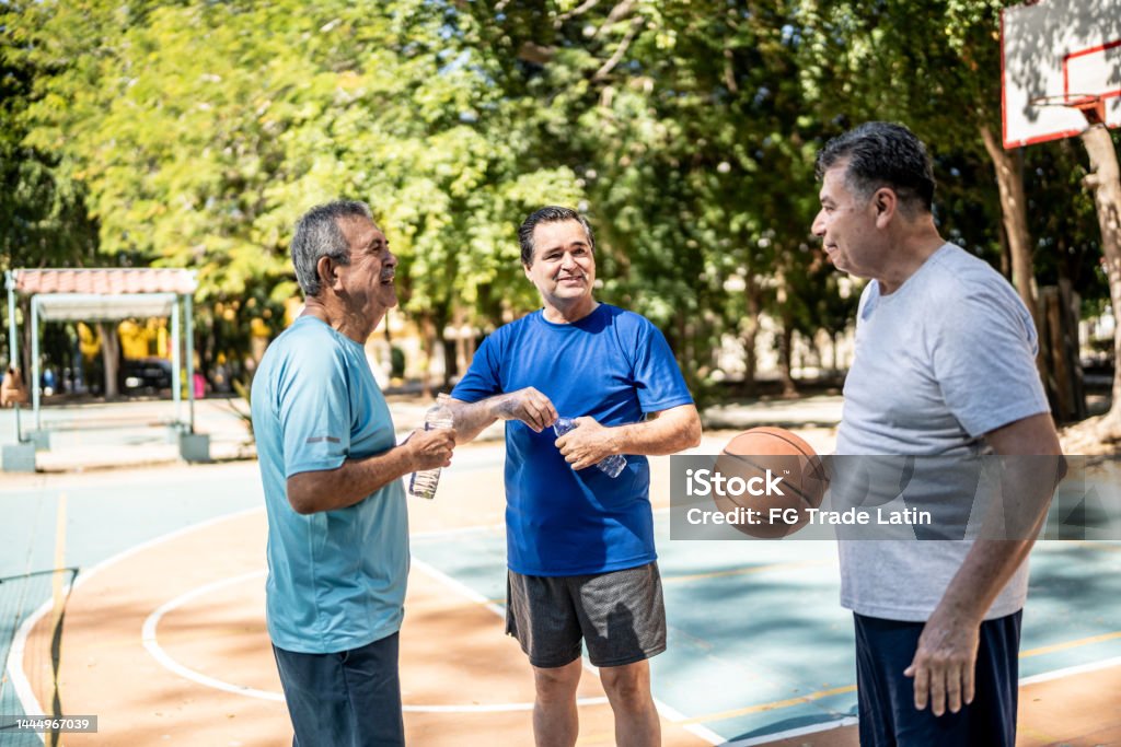 Senior friends talking at the basketball court 70-79 Years Stock Photo