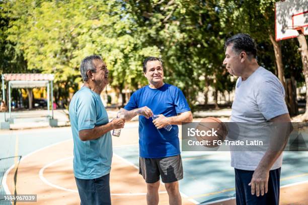 Senior Friends Talking At The Basketball Court Stock Photo - Download Image Now - 70-79 Years, Mexican Ethnicity, Mexico