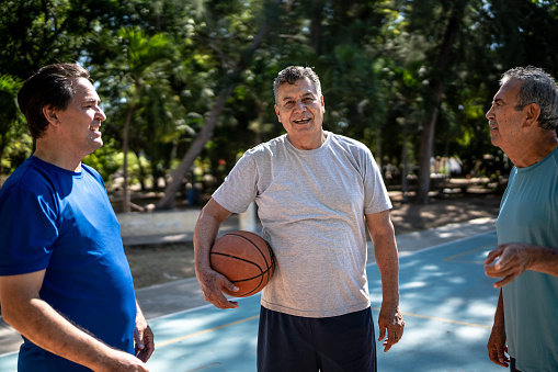 istock Portrait of mature man with friends at the basketball court 1444967144