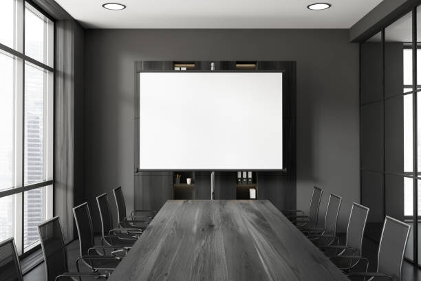 istock Grey office room with board and seats, panoramic window. Mockup projector screen 1444967279