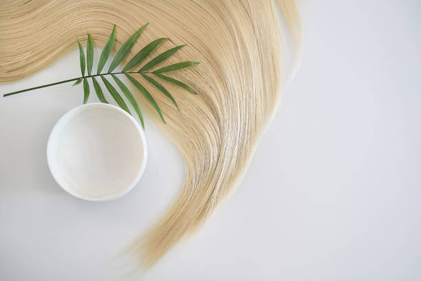 blonde female hair, balm or hair mask isolated on white background. Concept hairdresser spa salon. hair restoration and treatment after winter stock photo