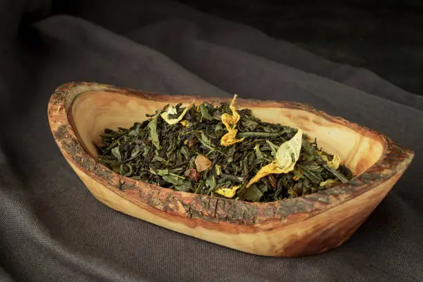 Full leaf loose green,black tea in wooden spoon