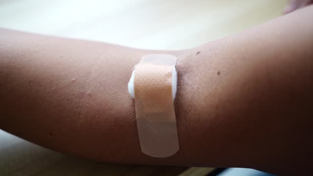 Medical plaster on arm after taking venipuncture