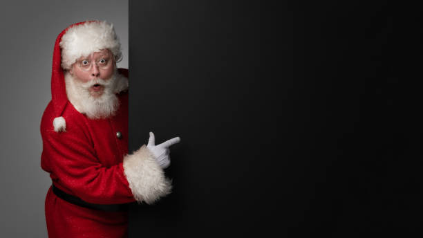istock Santa Claus pointing black billboard 1444969961