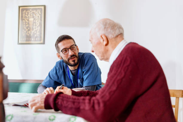 istock Caretaker with senior man enjoying coffee break 1444971218