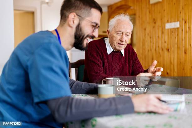 Caretaker With Senior Man Enjoying Coffee Break Stock Photo - Download Image Now - Senior Adult, Community Outreach, Home Caregiver