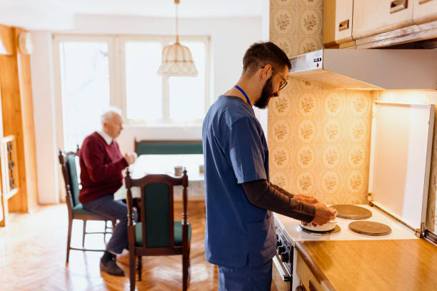 istock Caretaker preparing lunch for an elderly man 1444971366