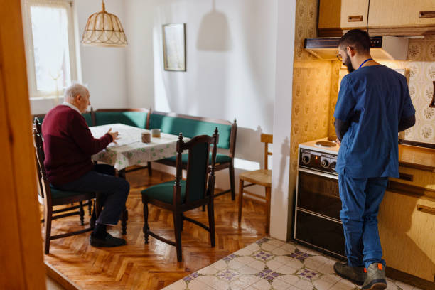 istock Caretaker preparing lunch for an elderly man 1444971450