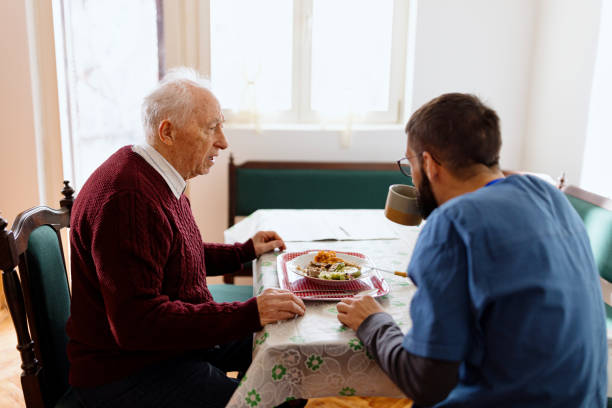 istock Home caregiver caring for a senior man 1444971894