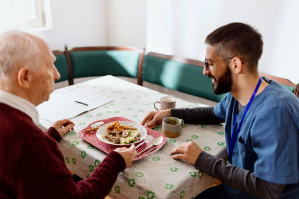 istock Home caregiver caring for a senior man 1444971896