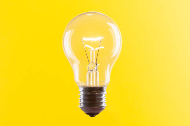 istock Old vintage light bulb close up on yellow background 1444971897