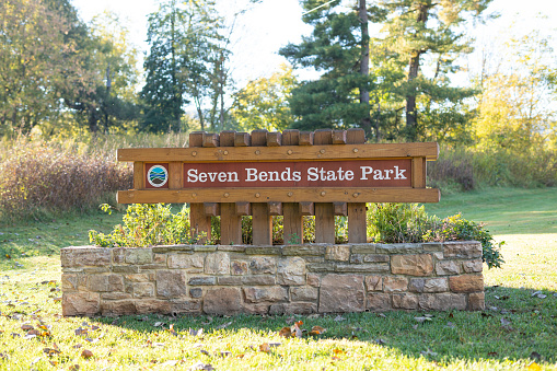 A close up photo of the sign for Seven Bends State Park in Virginia along the North Fork Shenandoah River.