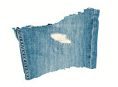 Scrap of grunge denim material close up on white background
