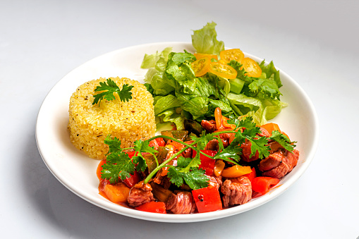 Chinese Traditional Fried Rice with shaky beef, vegetables served on a white plate high resolution stock photo