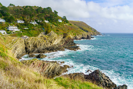 View of cliffs along the coastline of the village Polperro, in Cornwall, England, UK