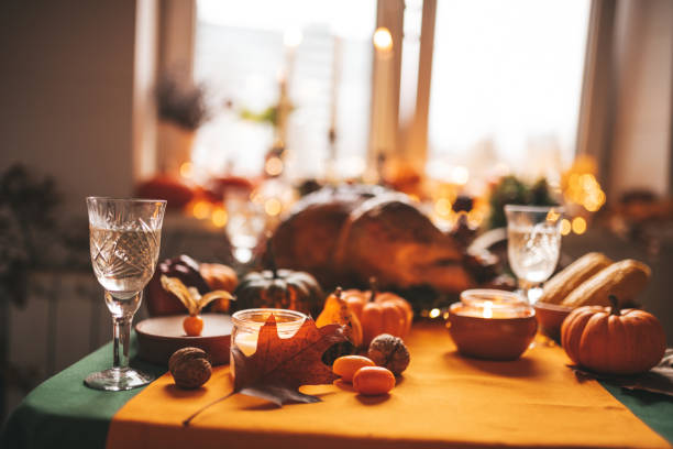 istock Thanksgiving holiday dinner table setting with fall decoration and pumpkins 1444976169