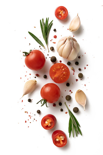 Ingredients for cooking, garlic, pepper, spices and herbs isolated on white background. top view. cherry tomatoes, garlic, ROSEMARY, SPICES