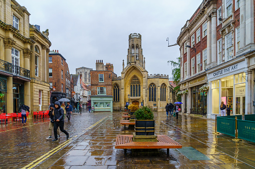 York, UK - September 22, 2022: Street scene, with the St Helen Church, locals, and visitors, in York, North Yorkshire, England, UK