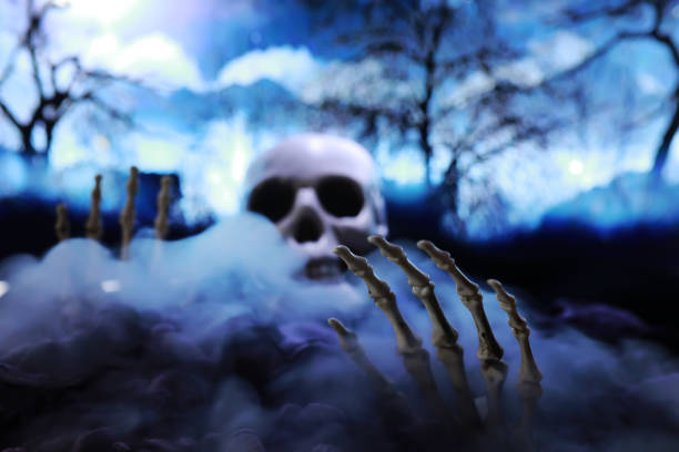 istock Skeleton Zombie Hand Rising Out Of A GraveYard - Halloween 1444978755
