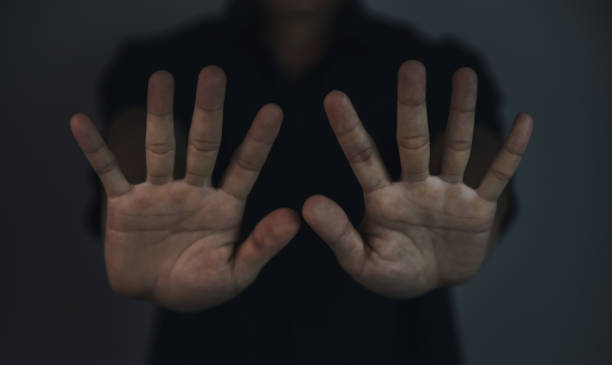istock A man raising both hands gestures stop the violence. Warning, prohibition, rejection. 1444979239