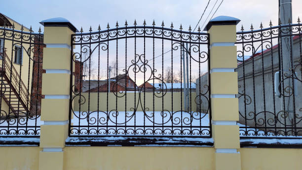 istock Metal fence grating with twisted decorations on a winter day 1444979553