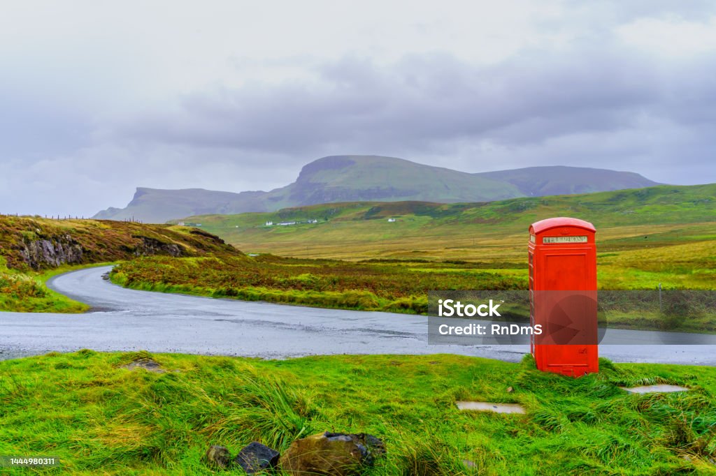 Countryside landscape, with a red phone box, Skye View of countryside landscape, with a red phone box, in the Isle of Skye, Inner Hebrides, Scotland, UK Telephone Booth Stock Photo