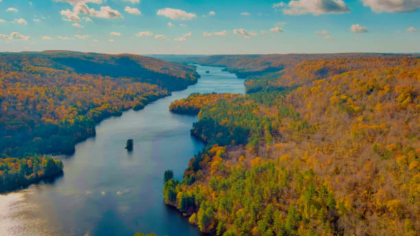 istock Autumn forest on the riverside, beautiful trees and blue river. Fall colors. View above. New England fall foliage in Connecticut (Falls Brook Falls Trail, near Hartland) 1444981010