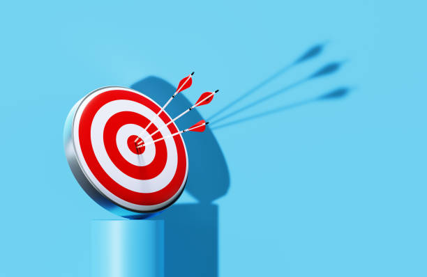 istock Red Bull's Eye Target On Blue Podium Before Blue Wall 1444984016