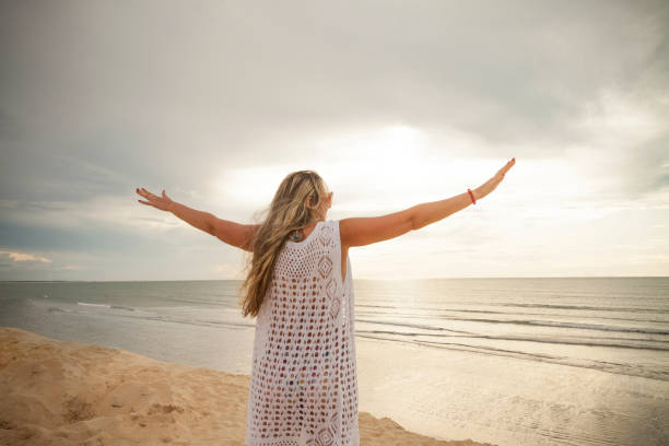 istock Woman with her back on dune at sunset. 1444985494