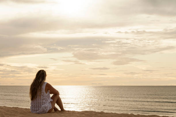 istock Woman with her back on dune at sunset. 1444985518