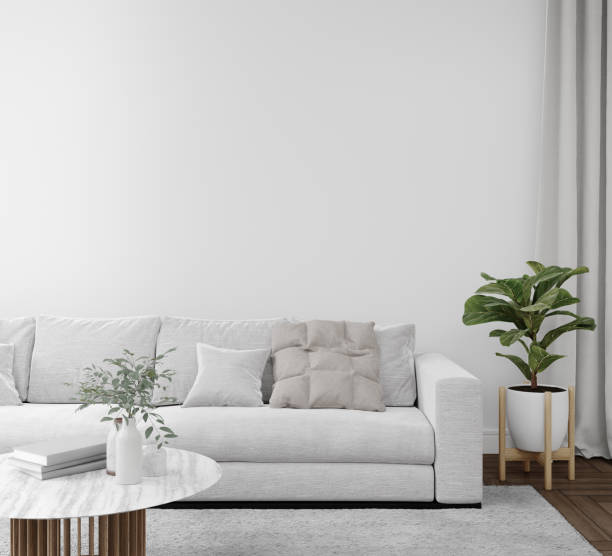 istock Empty white wall with sofa and carpet on wooden floor. 1444985733