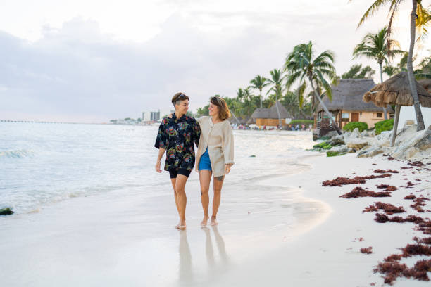 istock Lesbian couple walking down the beach 1444987196