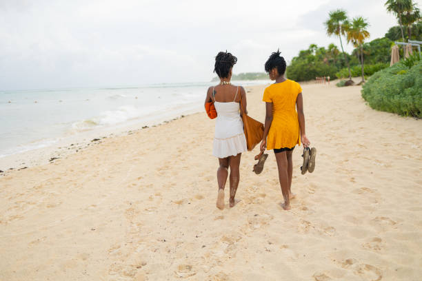 Mother and daughter are walking on the beach Mother and daughter are walking on the beach. They are spending the late afternoon at Playa del Carmen talking. family beach vacations travel stock pictures, royalty-free photos & images
