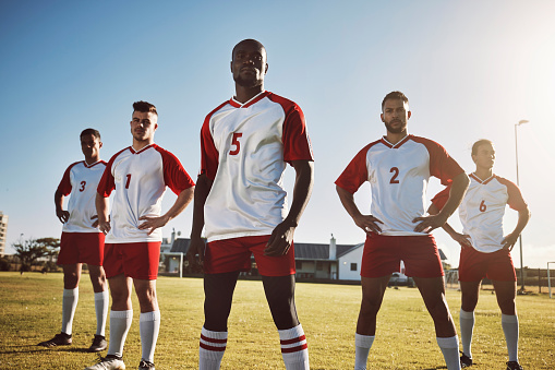 Football, soccer and portrait of team or group on field together ready for a match, game or competition. Fitness, diversity and men or players on grass field preparing for sports, workout or training