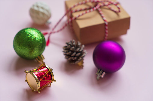 Christmas decoration made with ornaments on pink background