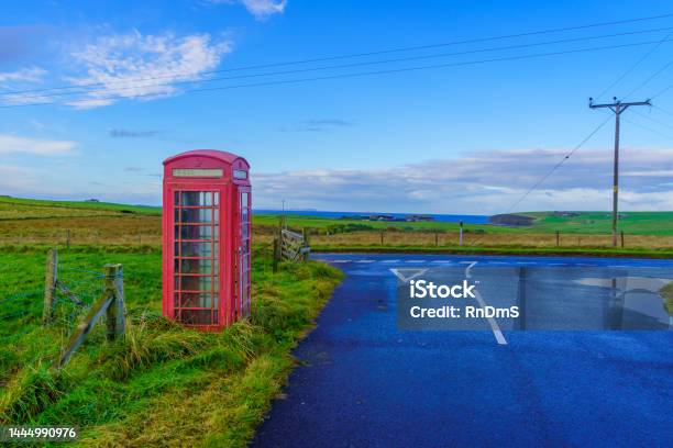 Red Phone Box In Landscape Of Fields Orkney Islands Stock Photo - Download Image Now