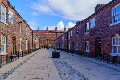View of an alley with old red bricks buildings, in the Ancoats neighborhood, Manchester, England, UK