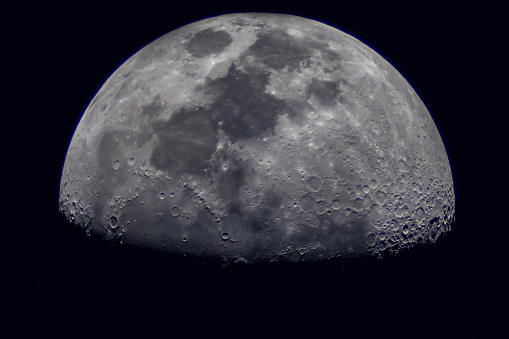 Surface of the Moon on black background, close up.