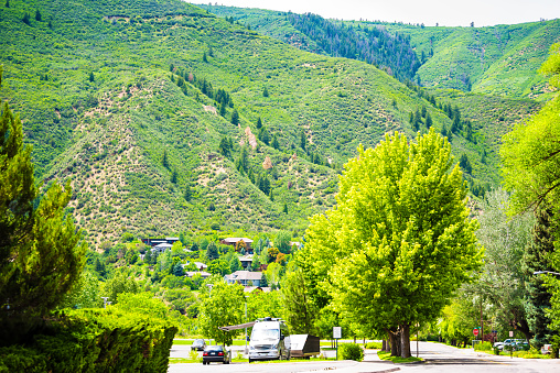 Glenwood Springs, Colorado residential street road in Colorado with houses homes on mountain with forest