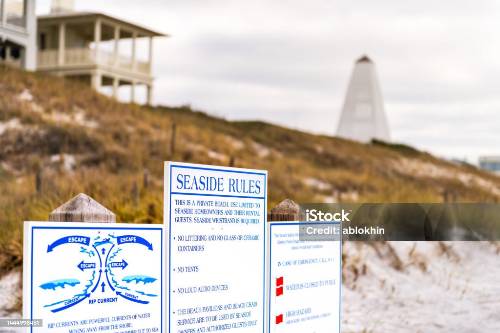 Seaside, Florida panhandle with beach rules sign poster for danger rip currents, no trash and littering in new urbanism small town city Community Stock Photo