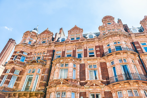 Apartment flats house building in Gothic revival style architecture in Mayfair, Westminster of London UK by Park lane street road near Hyde park