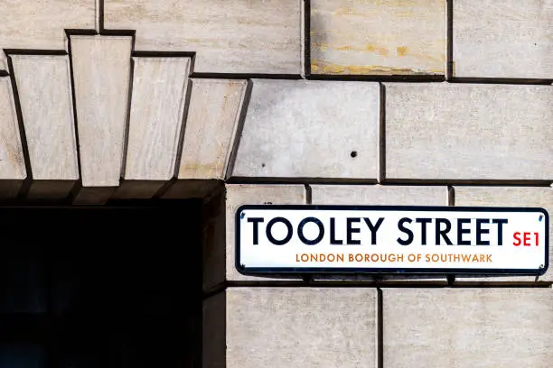 Closeup of Tooley street SE1 sign plate at London borough of Southwark on stone building wall